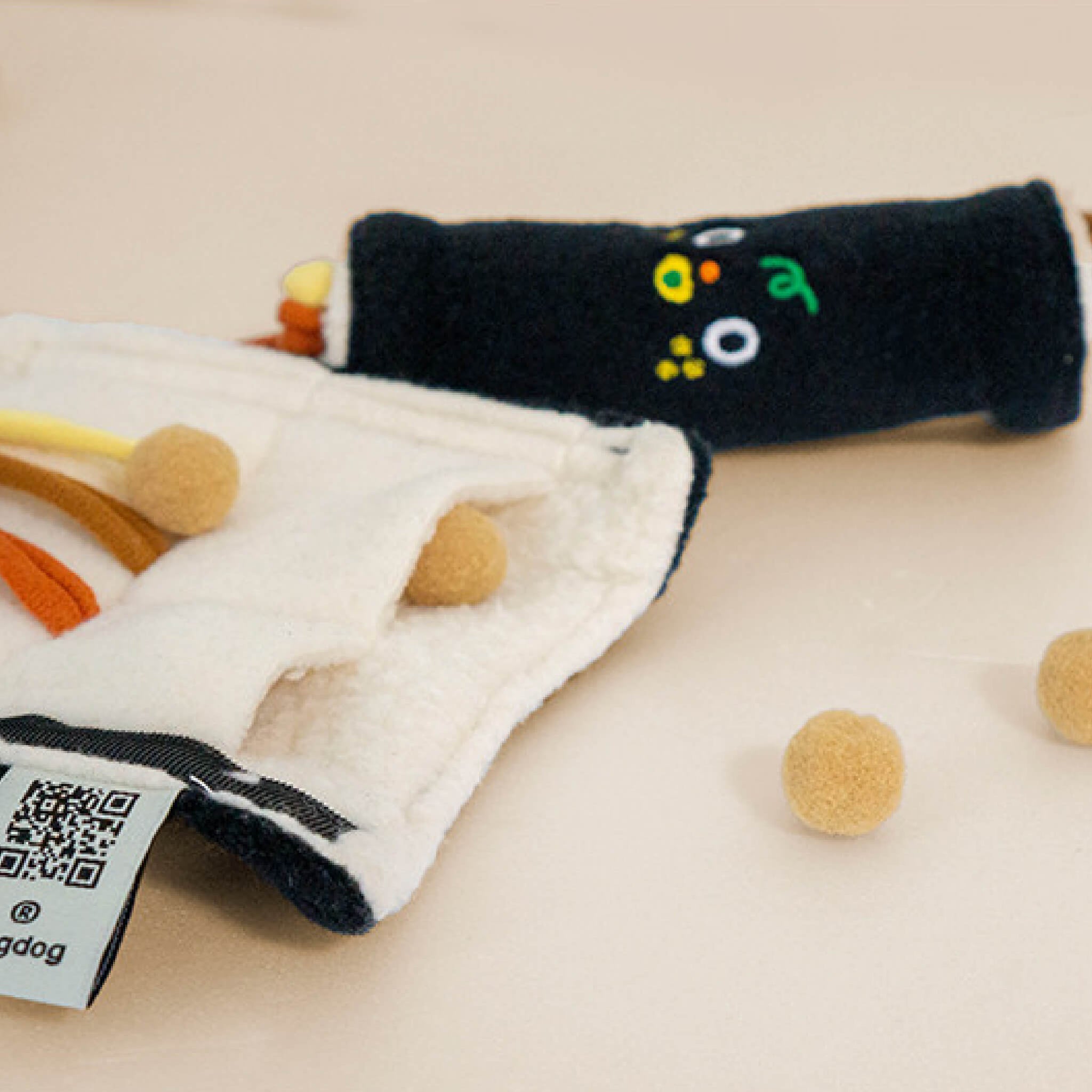 Strings and places for snack inside the mini gimbap nosework toy.