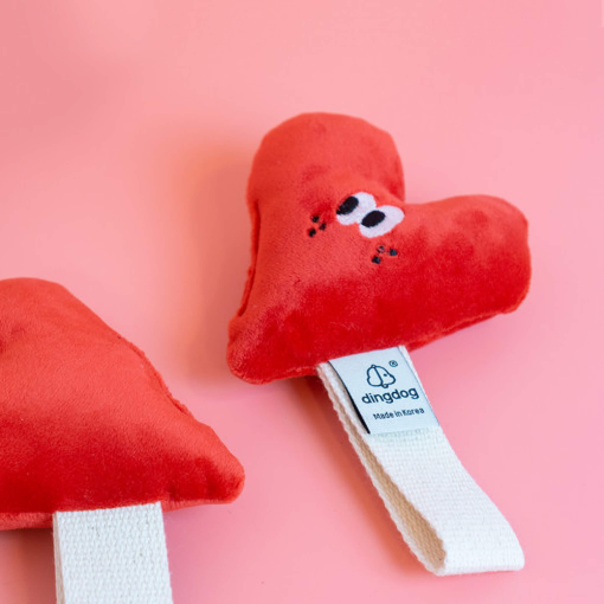 Heart toy with strap for tugging.