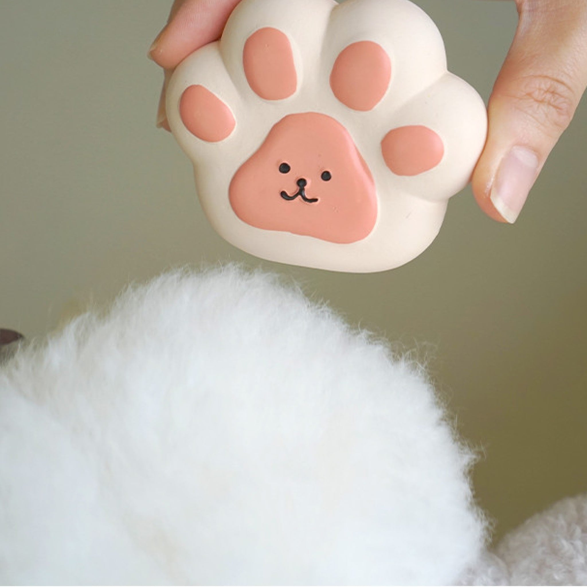 someone holding the jelly paw toy