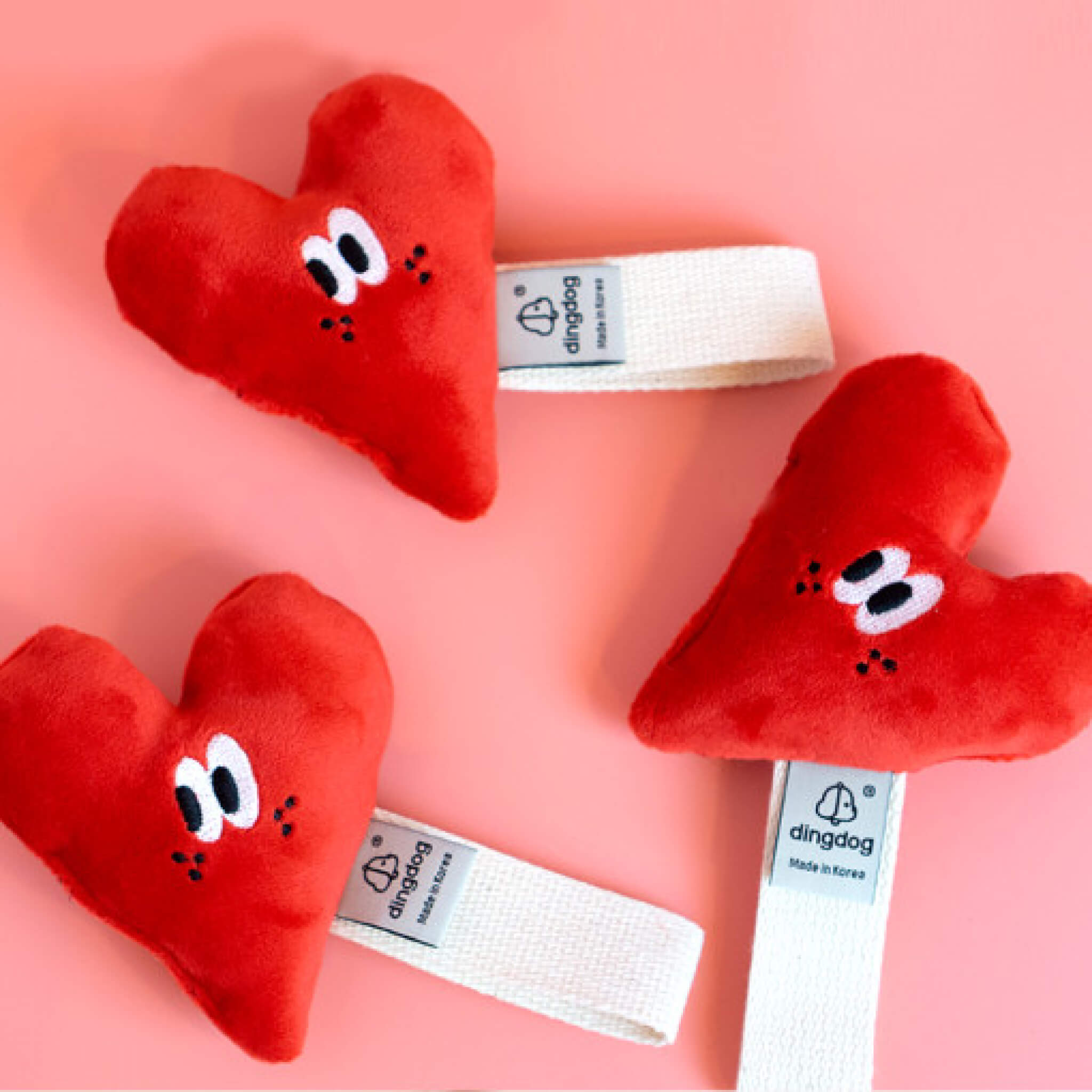 Heart toy with strap for tugging.