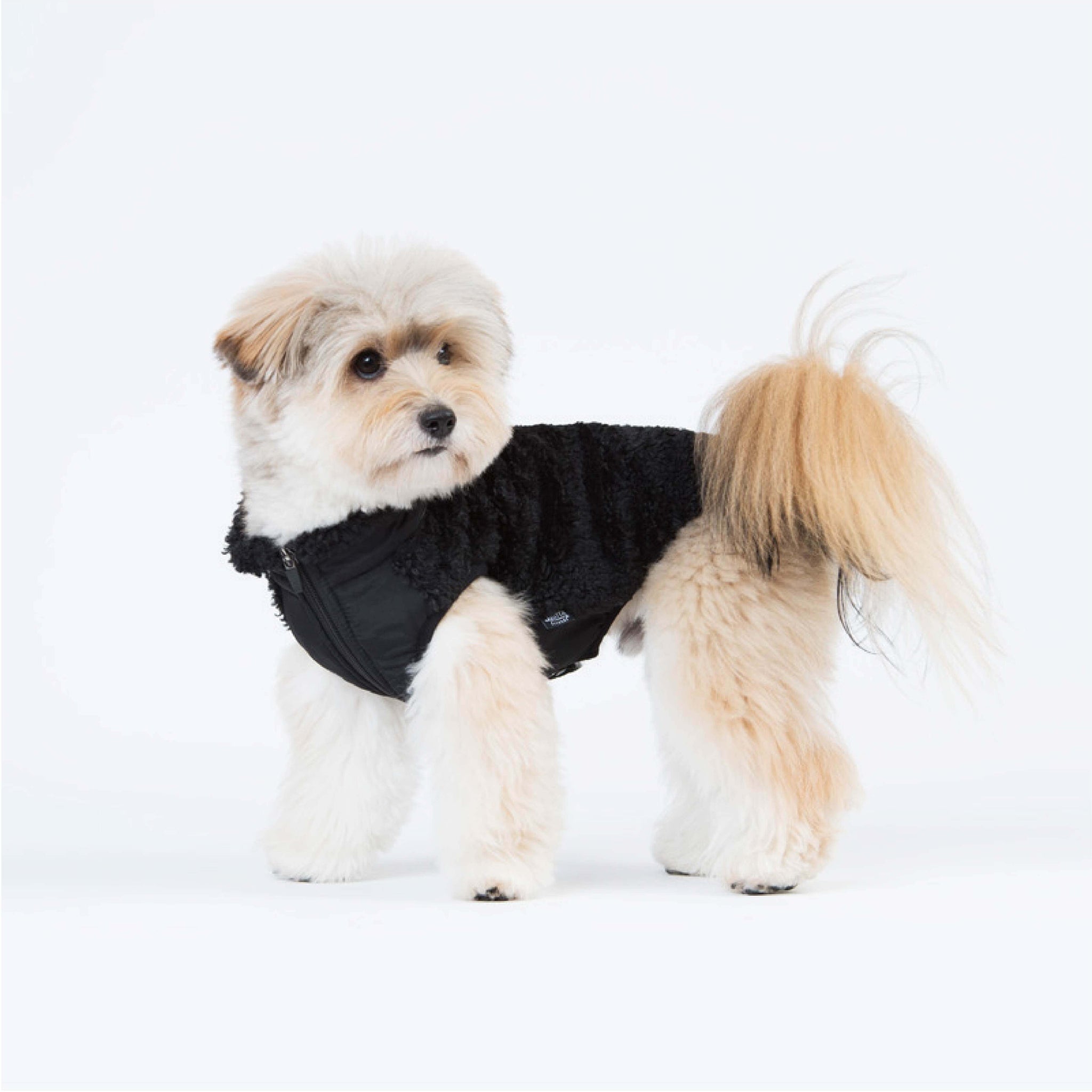 Zip-up vest made of sherpa fleece. Model is wearing a L & weighs 11 pounds (5 kg).