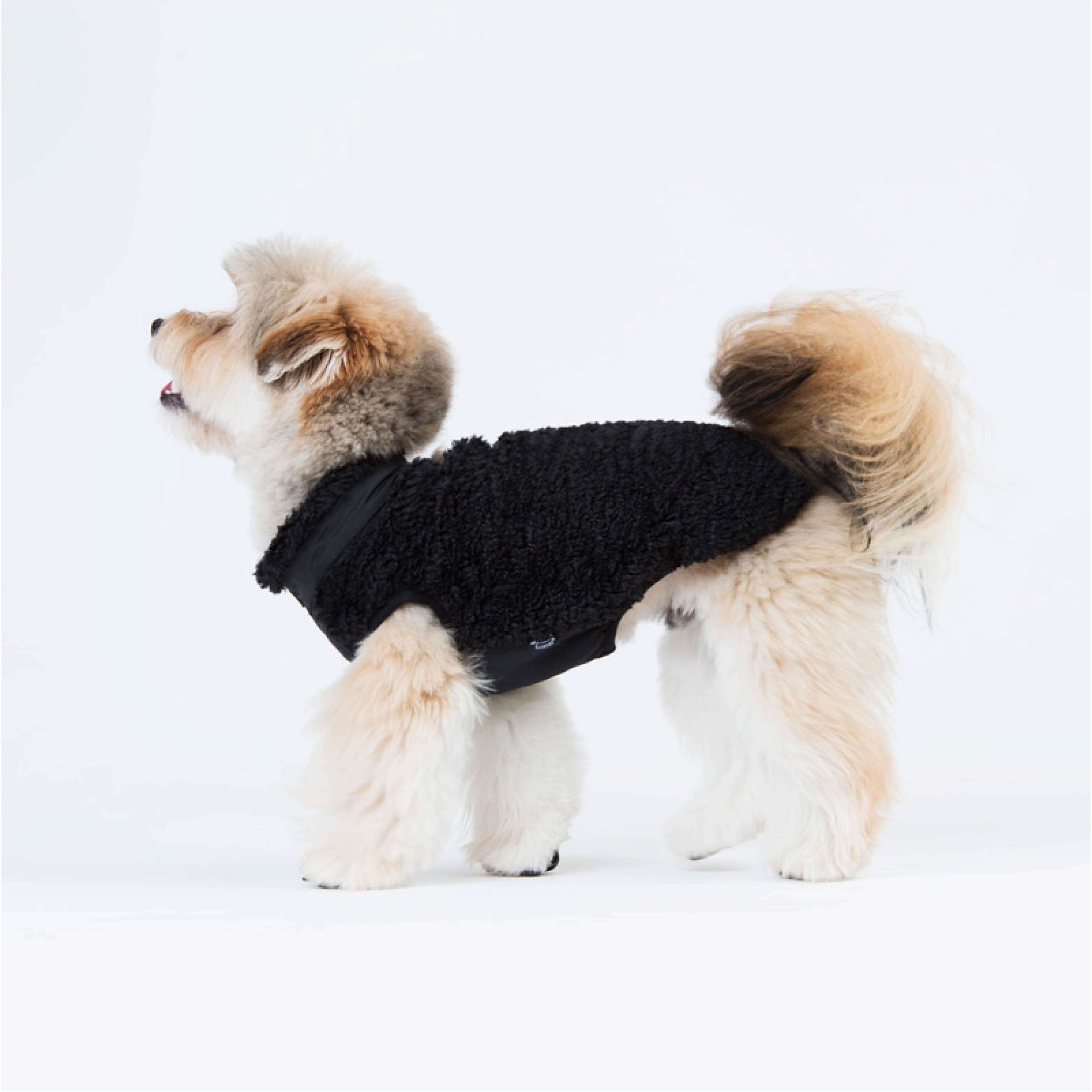 Zip-up vest made of sherpa fleece. Model is wearing a L & weighs 11 pounds (5 kg).