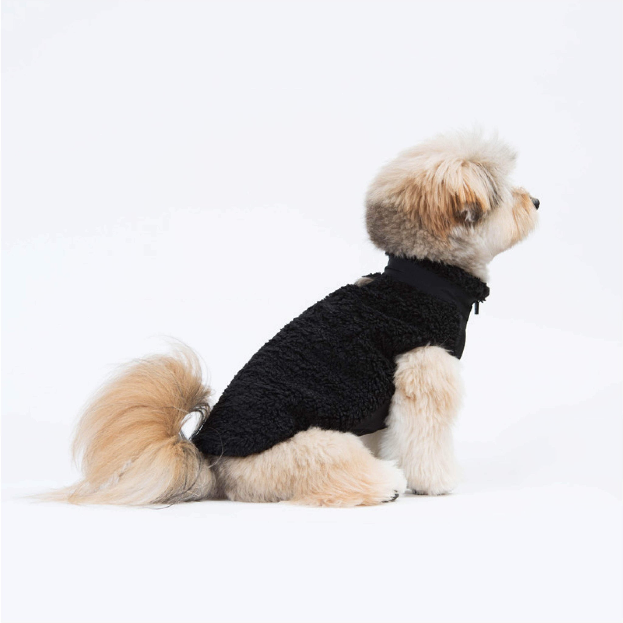 Zip-up vest made of sherpa fleece. Model is wearing a L & weighs 11 pounds (5 kg).