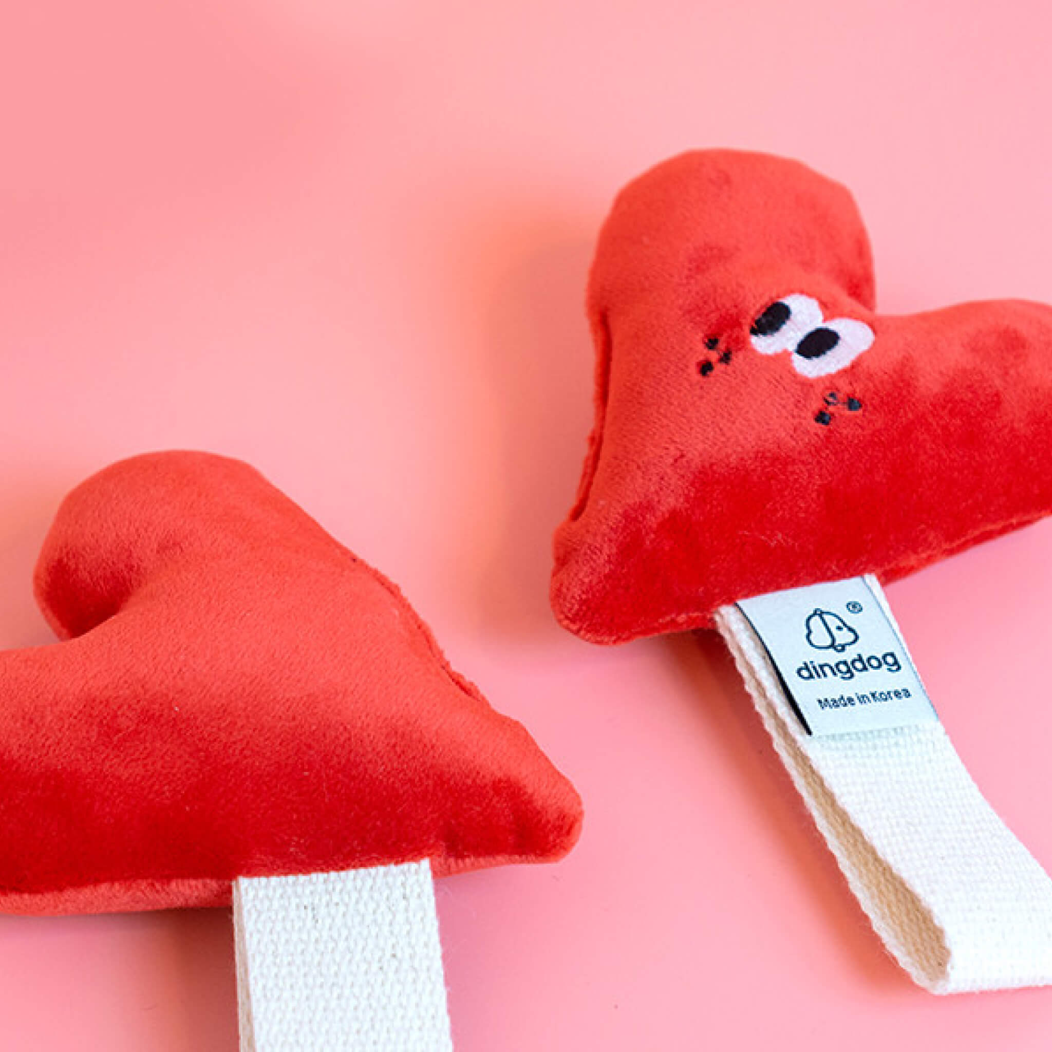 Heart toy with strap for tugging.