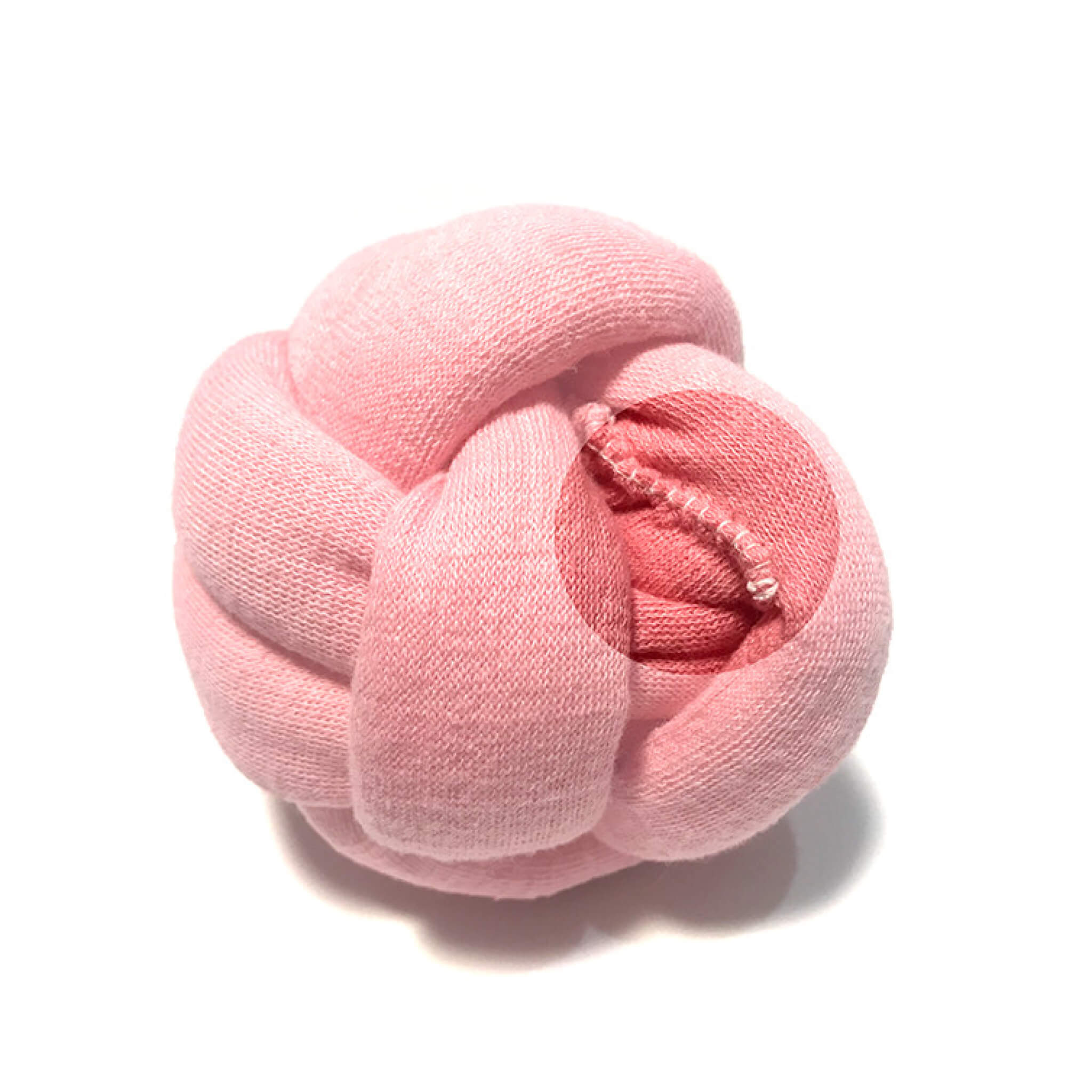 Stitching of pink knotted ball toy.