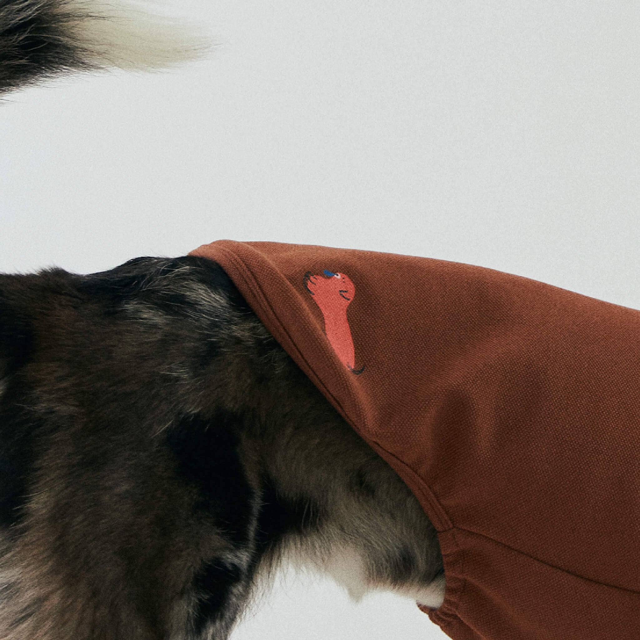 Upclose view of the printed character on the nies pullover in brown. Model is wearing a size 3L.