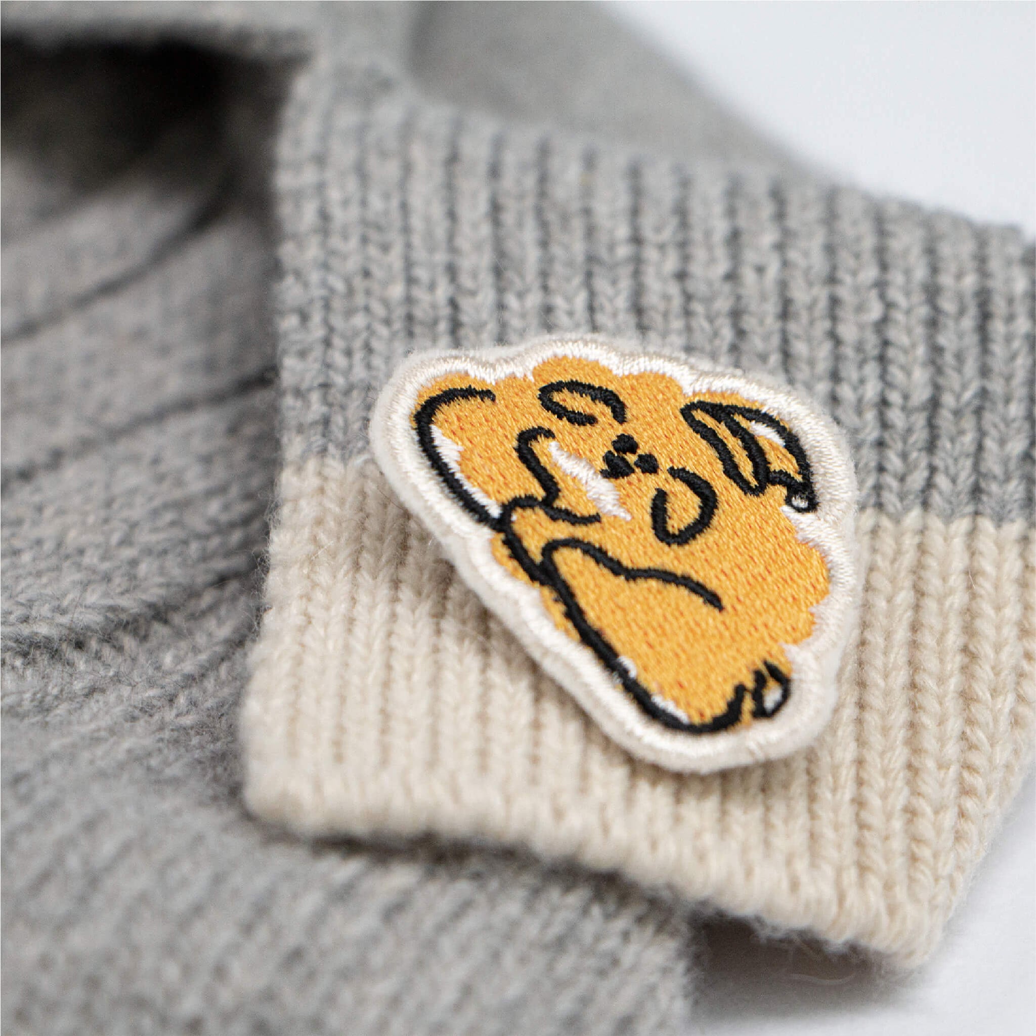 DOKT cashmere knit in grey and yellow. Comes with embroidered pin.